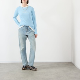Model wearing Pellador Waffle Logo Long-Sleeve T-Shirt in Baby Blue with light-wash straight-leg jeans and chunky trainers.
