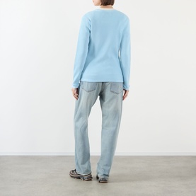 Model wearing Pellador Waffle Logo Long-Sleeve T-Shirt in Baby Blue, back view, styled with light wash straight-leg jeans.