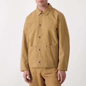 Model wearing Barbour Bayfield Logo Overshirt in camel, showing point collar, snap button placket and large patch pockets, styled with matching