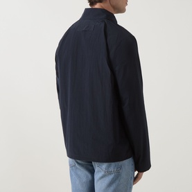 Model wearing Barbour Dark Navy casual jacket, rear view, styled with light blue jeans