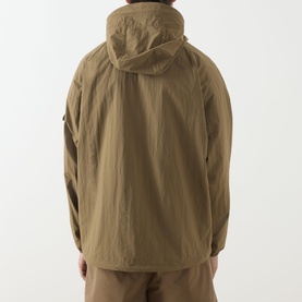Model wearing Barbour clay casual jacket, rear view showing hood and lightweight polyamide fabric, styled with matching trousers