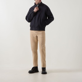 Model wearing Barbour navy cotton casual jacket, styled with beige chinos and black lace-up boots