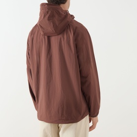 Model wearing Barbour Re-Engineered Flyweight Showerproof Jacket in Pepper, rear view showing hood, textured finish and adjustable hem drawcord