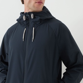 Model wearing Barbour navy casual jacket with adjustable hood, eyelet detailing, and contrast white drawstrings, close-up shot.