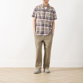 Model wearing Barbour Baycliff Logo Check Shirt in Burnt Pepper check, styled with khaki trousers and grey shoes