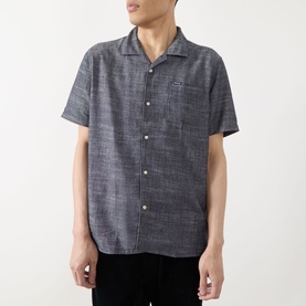 Model wearing Barbour Bowston Patch Pocket Logo Shirt in Dark Navy, camp collar, short sleeves, chest patch pocket, button front.