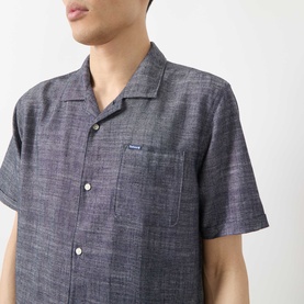Model wearing Barbour Bowston Patch Pocket Logo Shirt in Dark Navy, showing camp collar, short sleeves, and chest patch pocket detail.