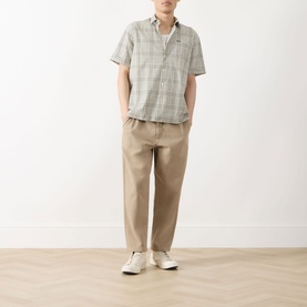 Model wearing Barbour Carrock Seersucker Check Print Shirt in Whisper White with beige chinos and white trainers.