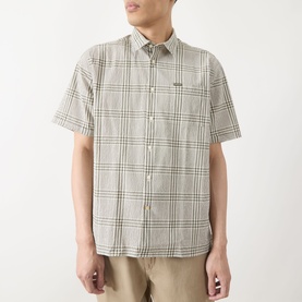 Model wearing Barbour Carrock Seersucker Check Print Shirt in Whisper White, short sleeves, point collar, styled with beige trousers