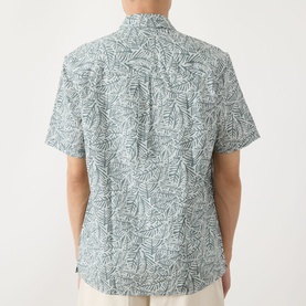 Model wearing Barbour Derham Patch Pocket Printed Shirt in Dusty Slate, rear view, short sleeves, all-over leaf print on linen-cotton fabric