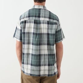 Model wearing Barbour casual shirt in Meadow Brook Tartan, green and cream check, short sleeves, back view, styled with khaki trousers.