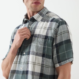 Model wearing Barbour casual shirt in Meadow Brook Tartan, green and cream large check, short sleeves, chest pocket, linen-lyocell blend