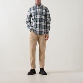 Model wearing Barbour Rawley Tartan Shirt in Meadow Brook Tartan, styled with beige chinos and black lace-up shoes.