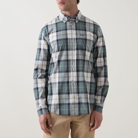 Model wearing Barbour Rawley Tartan Shirt in Meadow Brook Tartan, button-down collar, chest pocket, paired with stone chinos.