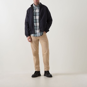 Model wearing Barbour Rawley Tartan Shirt in Meadow Brook Tartan, styled with navy jacket, beige chinos and black boots.