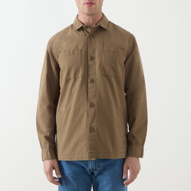 Model wearing khaki cotton overshirt with chest pockets and button front, styled with blue jeans