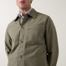 Model wearing Barbour Dusty Olive cotton casual shirt with chest pocket and button front, styled with a light check shirt underneath