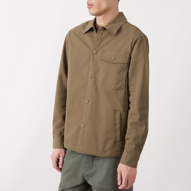 Model wearing Barbour Strick Flap Pocket Overshirt in Clay, featuring shirt collar, chest flap pocket and front snap button placket, styled with