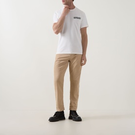 Model wearing Barbour Whisper White crew neck T-shirt with chest logo, styled with beige chinos and black lace-up boots