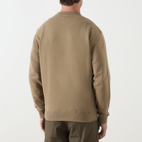 Model wearing Barbour clay cotton crew neck sweatshirt, back view, styled with khaki trousers