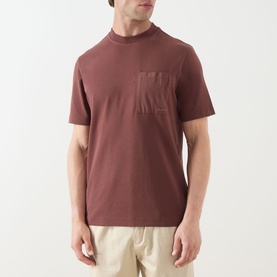 Model wearing Barbour Ivergill Patch Pocket T-Shirt in Burnt Pepper with embroidered logo chest pocket, styled with beige trousers.