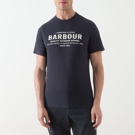 Model wearing Barbour Dark Navy crew neck T-shirt with white logo graphic print to chest, styled with dark trousers.