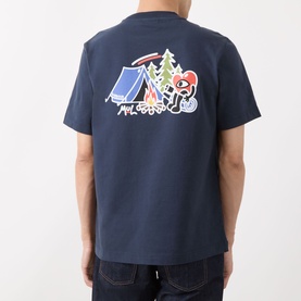 Model wearing Barbour Camping Trip T-Shirt in Navy, showing rear camping graphic print with tent and Running Heart motif, styled with dark jeans.
