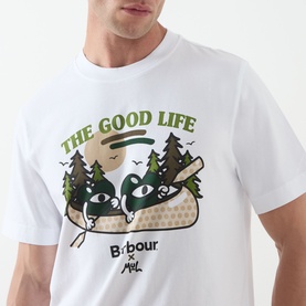 Model wearing white Barbour x Mint graphic T-shirt with The Good Life forest print in green and tan tones