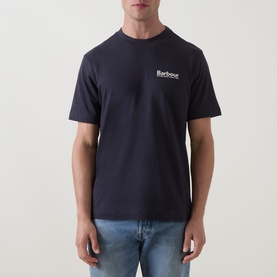 Model wearing Barbour Moonwell Graphic Logo T-Shirt in Dark Navy, crew neck with chest logo, styled with light blue jeans.