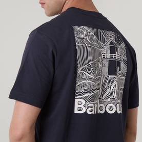 Model wearing Barbour Moonwell Graphic Logo T-Shirt in Dark Navy, showing rear lighthouse graphic print with Barbour branding.