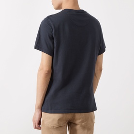 Model wearing Barbour Teeside Graphic Logo T-Shirt in Dark Navy, rear view, crew neck, short sleeves, styled with beige chinos