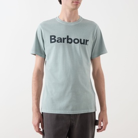 Model wearing Barbour Washington Overdyed Logo T-Shirt in Dusty Slate, crew neck with contrast chest logo, paired with grey trousers