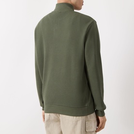 Model wearing Barbour International Thyme half zip sweatshirt, rear view, styled with stone cargo trousers.