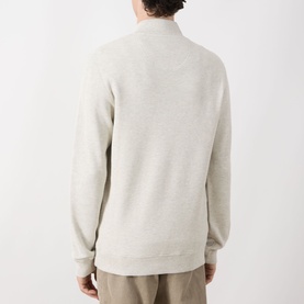Model wearing Barbour Raven Logo Half-Zip Sweater in Ecru Marl, rear view showing ribbed trims and straight hemline
