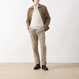 Model wearing Barbour Raven Logo Half-Zip Sweater in Ecru Marl, styled with tan jacket and beige trousers