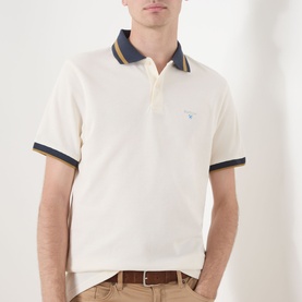 Model wearing Barbour Anthorn Textured Logo Polo Shirt in Whisper White with navy and gold tipped collar and cuff trims.
