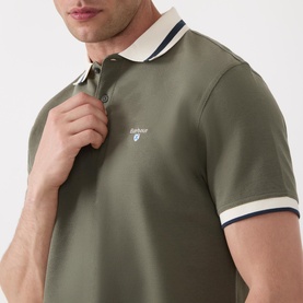 Model wearing Barbour Anthorn Textured Logo Polo Shirt in Dusty Olive with cream and navy tipped collar and sleeve ribbing