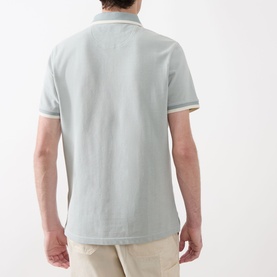 Model wearing Barbour Barnard Logo Polo Shirt in Dusty Slate, rear view, with contrast tipped collar and cuffs, paired with stone chinos.
