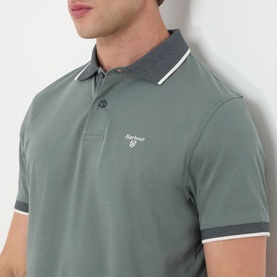 Model wearing Barbour polo shirt in Vintage Teal with contrast tipped collar and short sleeves, Barbour logo embroidered at chest.