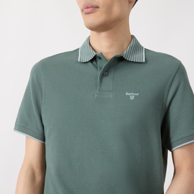 Model wearing Barbour Vintage Teal polo shirt with striped collar and short sleeves, Barbour logo embroidered on chest