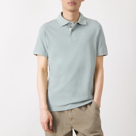 Model wearing Barbour polo shirt in Dusty Slate, short-sleeved piqu&eacute; fabric with classic collar, styled with stone chinos.