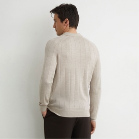 Model wearing Reiss stone moulin&eacute; knit jumper, back view, with ribbed vertical texture detail and dark trousers.