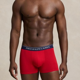 Model wearing Ralph Lauren Classic Stretch Trunk in RL Red with navy logo elastic waistband, from a 3-pack set.