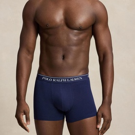 Model wearing Ralph Lauren Classic Stretch Trunk in navy with signature logo elastic waistband, part of a 3-pack set