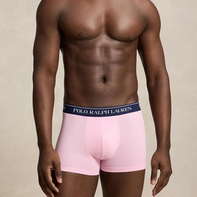 Model wearing Ralph Lauren Classic Stretch Trunk in carmel pink with navy logo elastic waistband, contoured pouch, part of 3-pack set.
