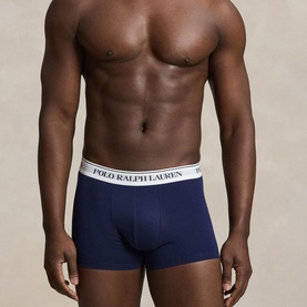 Model wearing Ralph Lauren Classic Stretch Trunk 3-Pack in navy, with signature logo elastic waistband. Part of a navy, red and pebble blue set.