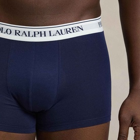 Model wearing Ralph Lauren Classic Stretch Trunk in navy, featuring signature logo elastic waistband. Part of a 3-pack set.