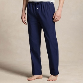Model wearing navy blue drawstring lounge trousers with small logo embroidery, styled with a white crew-neck top