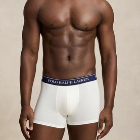 Model wearing Ralph Lauren Classic Stretch Trunk 5-Pack in white with navy logo elastic waistband, trunk style with contoured pouch