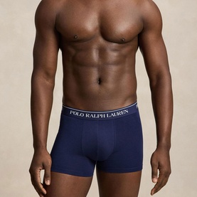 Model wearing Ralph Lauren Classic Stretch Trunk in navy, featuring signature Polo Ralph Lauren logo elastic waistband and contoured pouch fit.